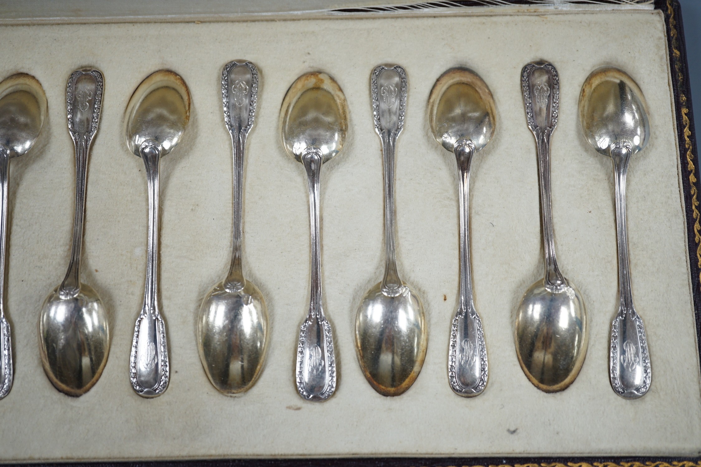 A cased set of twelve early 20th century French 950 white metal teaspoons by Emile Puiforcat, retailed by Louis Rey, 10.5cm.